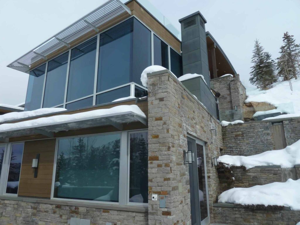 Close up exterior view of Sesame development displaying large windows and stone siding