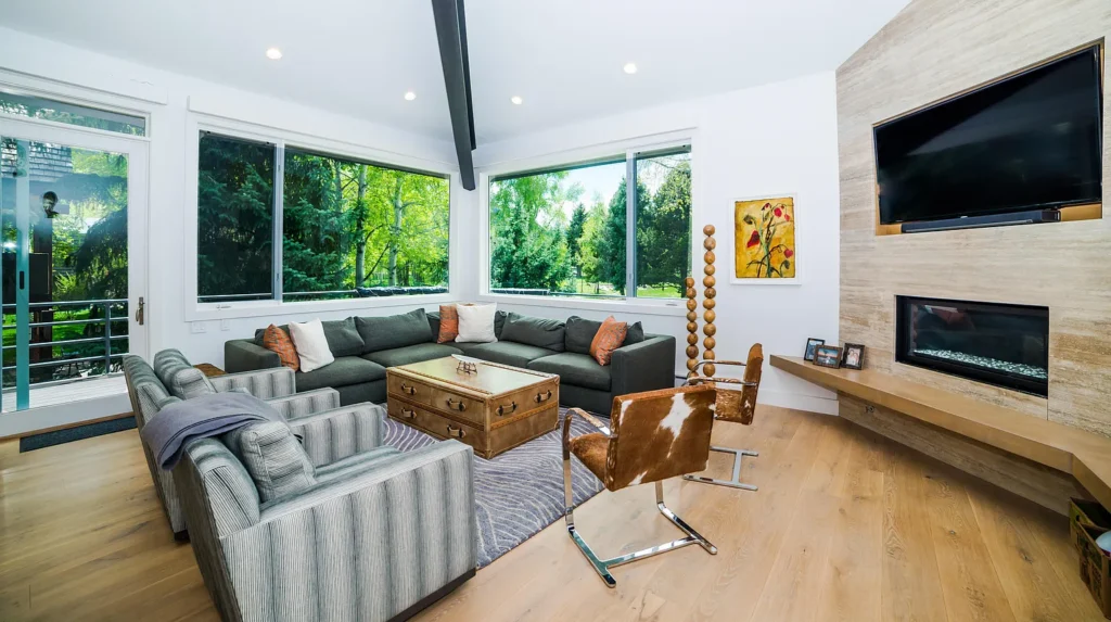 Interior view of Golf Lane living area with large screen tv and large windows