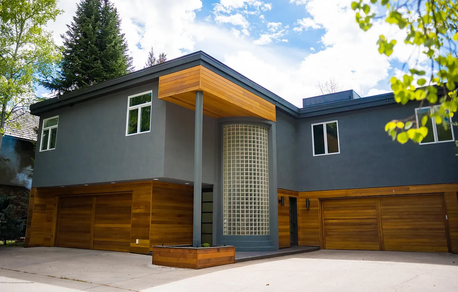 Exterior view of at Golf Lane revealing top half gray siding and bottom half wood siding