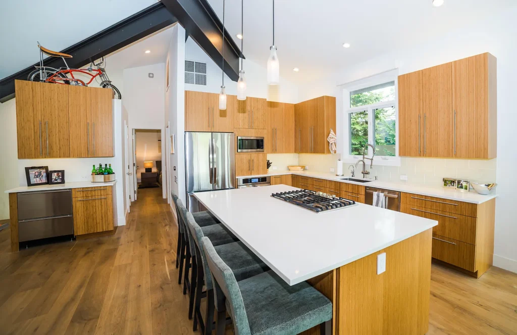 Interior view of Golf Lane kitchen area with slanted ceilings and island with grill top