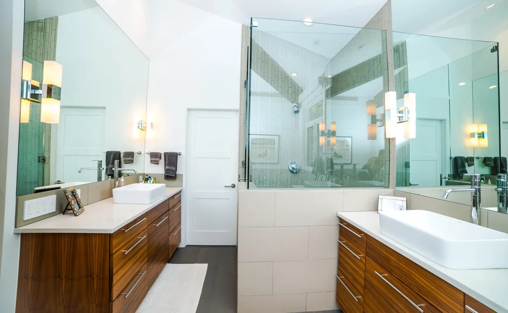 Interior bathroom view of Golf Lane with stone and tempered glass shower