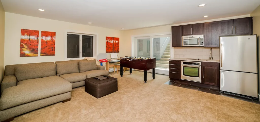 Living room and kitchen area with foosball table at Golf Lane