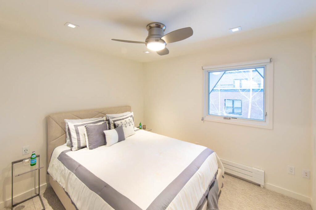 Interior view of simple clean guest bedroom at Cooper Ave