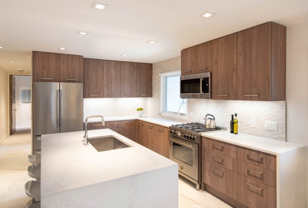 Interior view of kitchen including tea pot and view of guest bedroom from afar at Cooper Ave