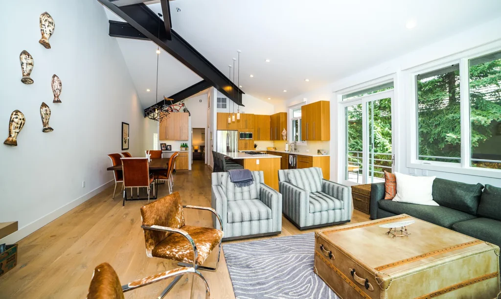 Interior living room area with striped chairs over looking kitchen and dining room at Golf Lane