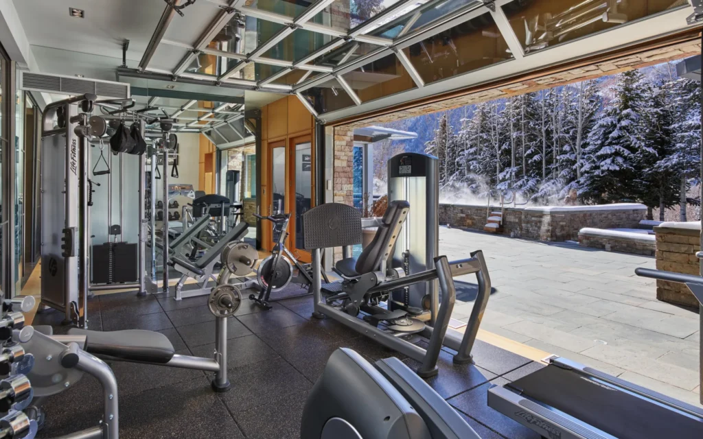 Exterior gym with equipment inside garage area at Smuggler Mountain Residence