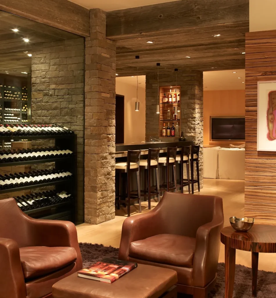 Interior wine rack and leather couches in living area at Smuggler Mountain Residence