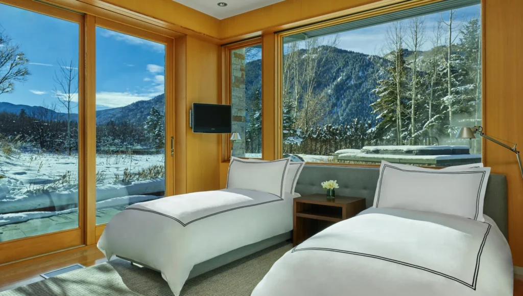 Interior guest bedroom with large bay windows at Smuggler Mountain Residence