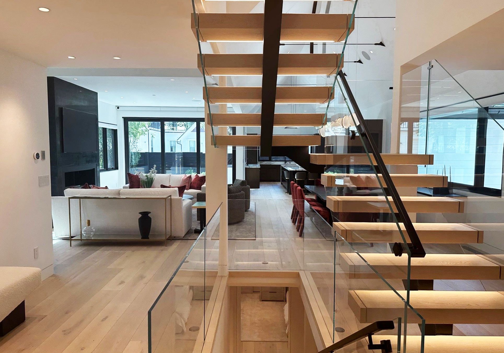 Beautiful glass and wooden stairway overlooking living room and kitchen at Smuggler